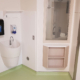 Patient room corner cabinet with open shelves beside handwash sink at SickKids Ward 5B