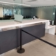 Long public service counter at Guelph Police Department with lower accessible section and glass partitions