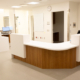 Hospital nursing station with white counters and wood-grain front at Grey Bruce Health Services Markdale Hospital