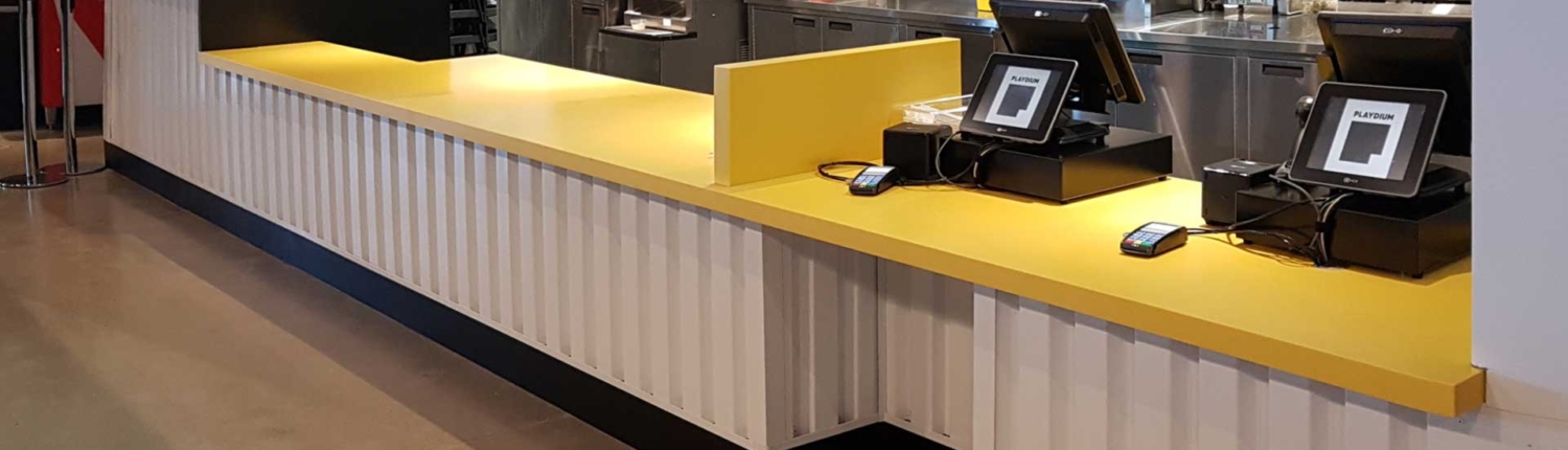 Food service counter with yellow top and white front at Playdium Whitby