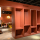 Terracotta display bays with wall sconce beside a furniture vignette at South Hill Home